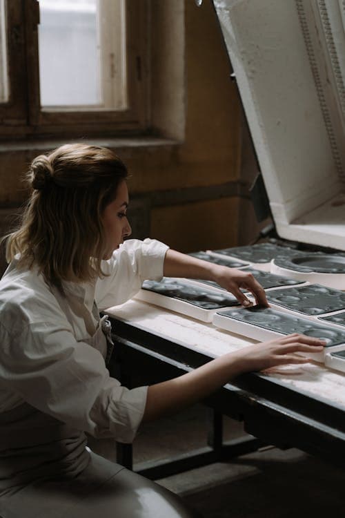 Small manufacturing facility with modern ERP dashboards on screens showing production and inventory data