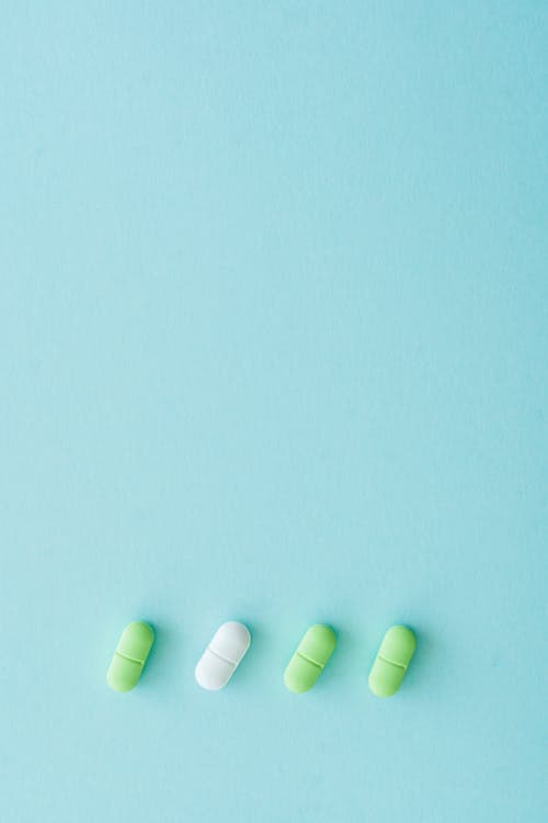 Pharmaceutical ERP audit trail with green and white tablets