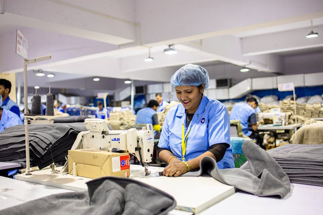 Yarn warehouse with digital inventory tracking system showing bin locations, stock levels, and aging analysis